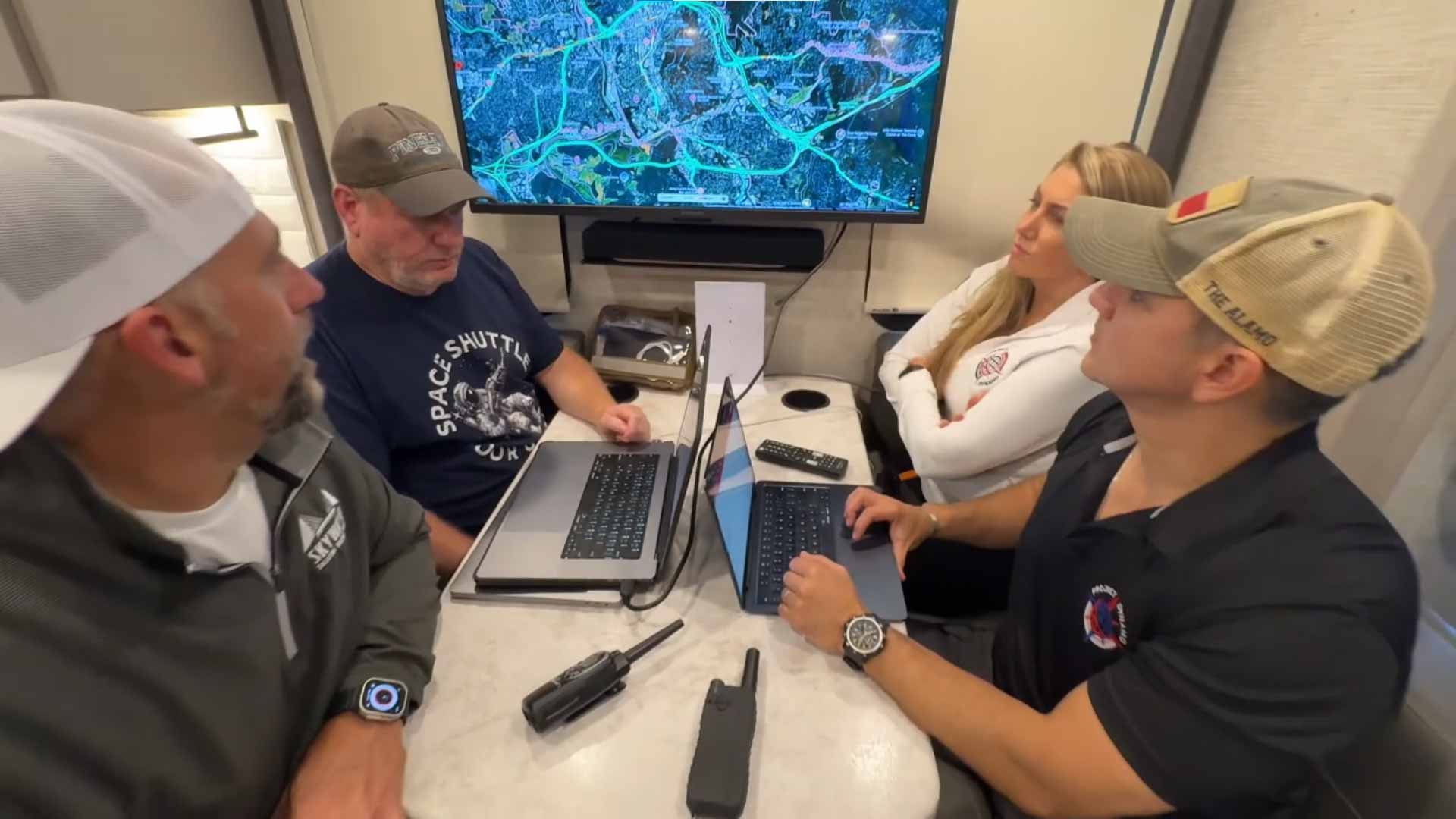 Project DYNAMO team coordinating operations with laptops and a map